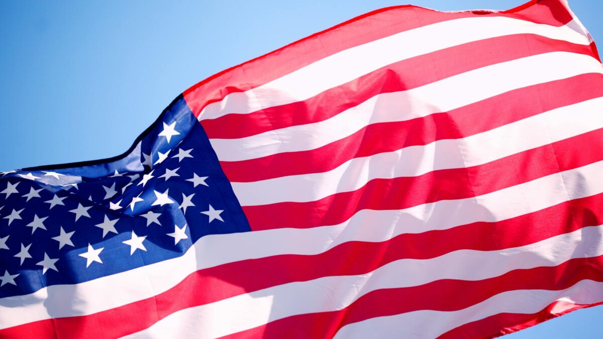 american flag under blue sky